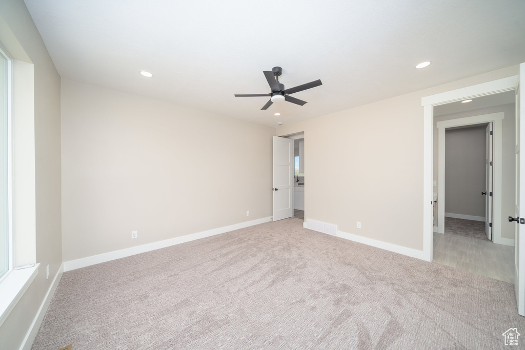 Unfurnished bedroom with light colored carpet, baseboards, and recessed lighting