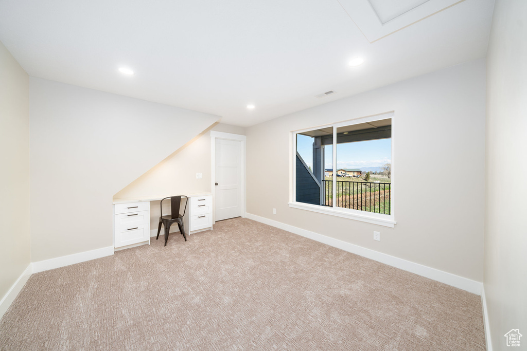 Unfurnished office featuring light carpet, baseboards, and recessed lighting