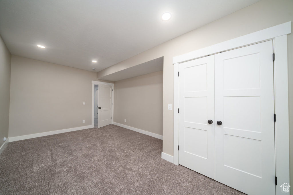 Finished below grade area featuring carpet flooring, baseboards, and recessed lighting
