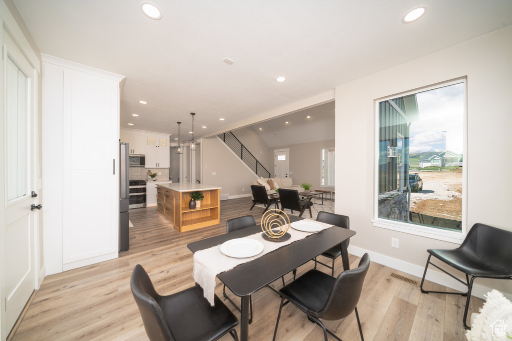 Dining space featuring stairway, recessed lighting, baseboards, and light wood-style floors