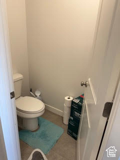 Bathroom featuring baseboards and toilet