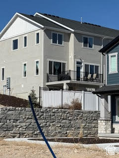 Back of house featuring a balcony