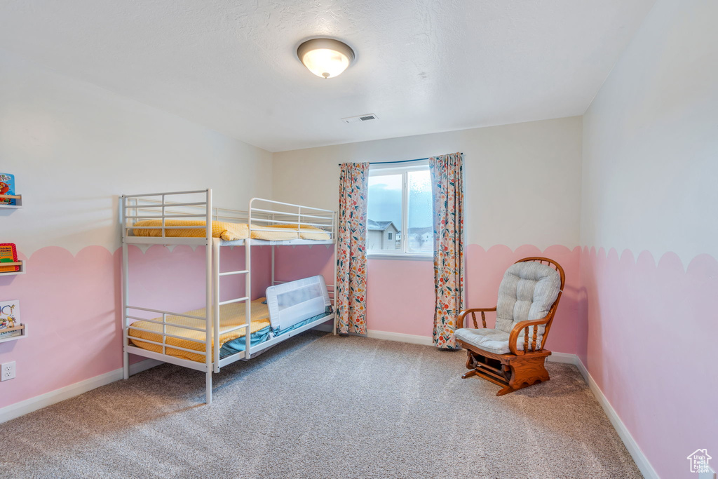 Bedroom with visible vents, carpet floors, and baseboards