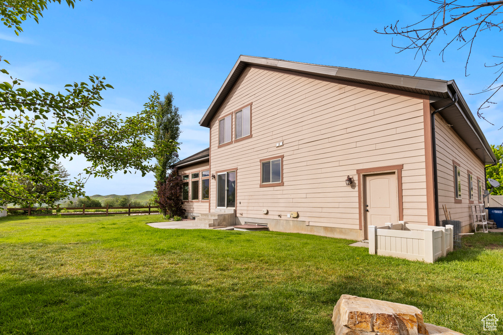 Back of house featuring a yard and a patio area