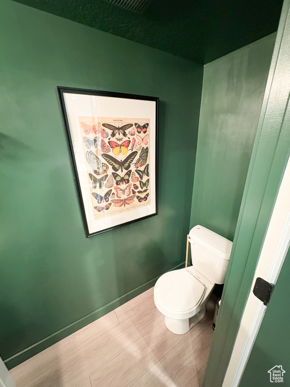 Bathroom featuring toilet and baseboards