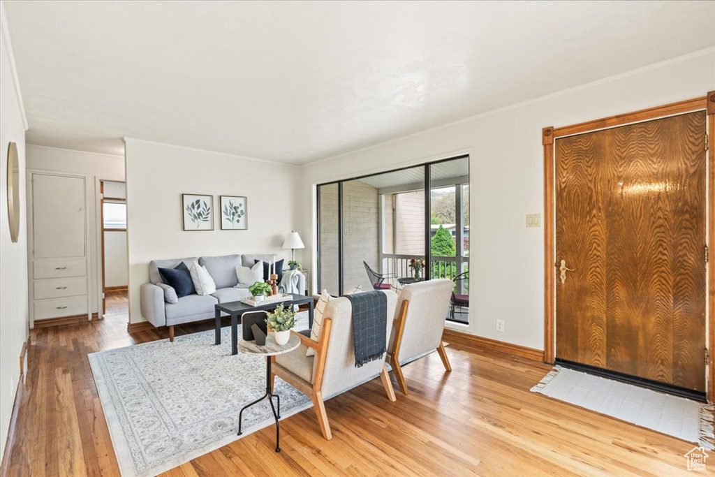 Living area featuring light wood-style flooring and baseboards