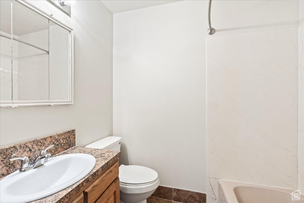 Bathroom with tile patterned floors, toilet, and vanity