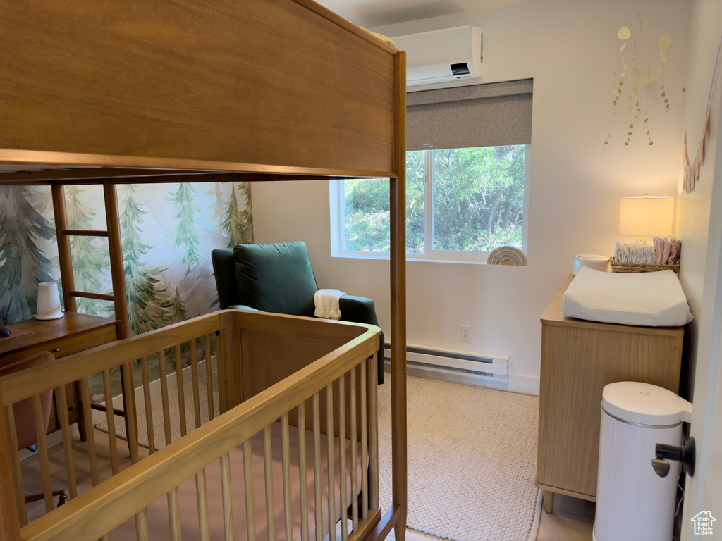 Bedroom with a crib and a baseboard radiator
