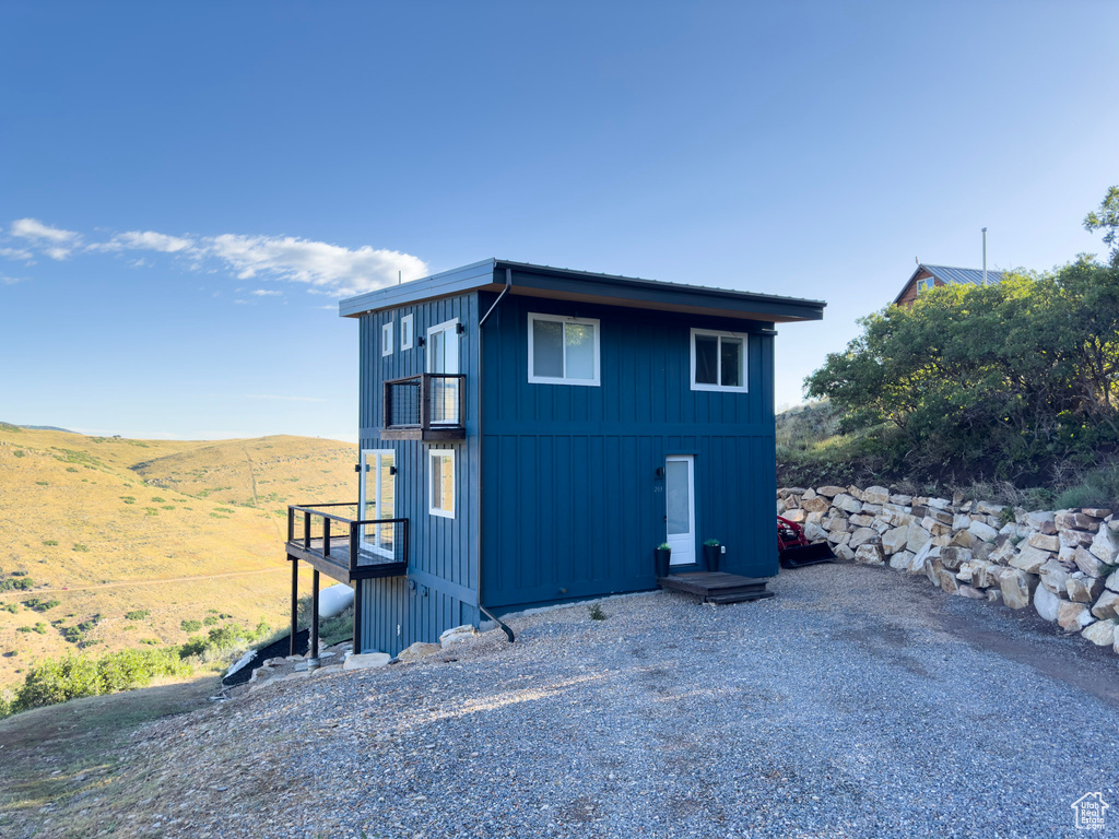 Exterior space with a mountain view and board and batten siding