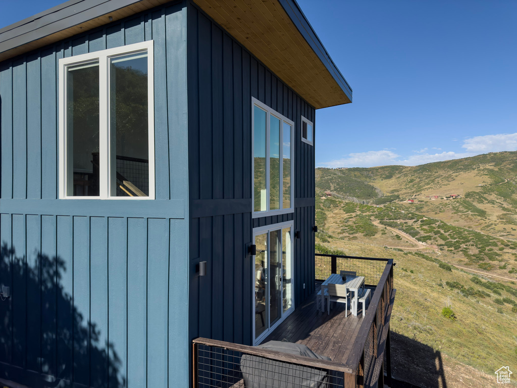 View of home\\\'s exterior with board and batten siding and a mountain view