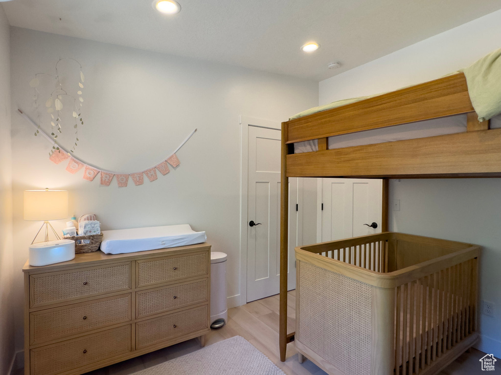 Bedroom with light wood finished floors and recessed lighting
