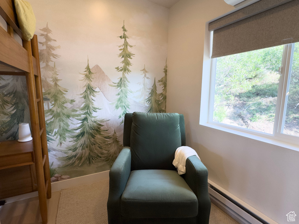 Sitting room featuring a baseboard heating unit