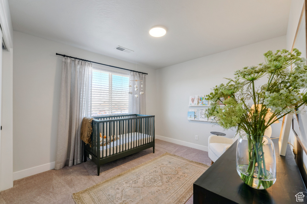 Bedroom featuring visible vents, carpet flooring, and baseboards