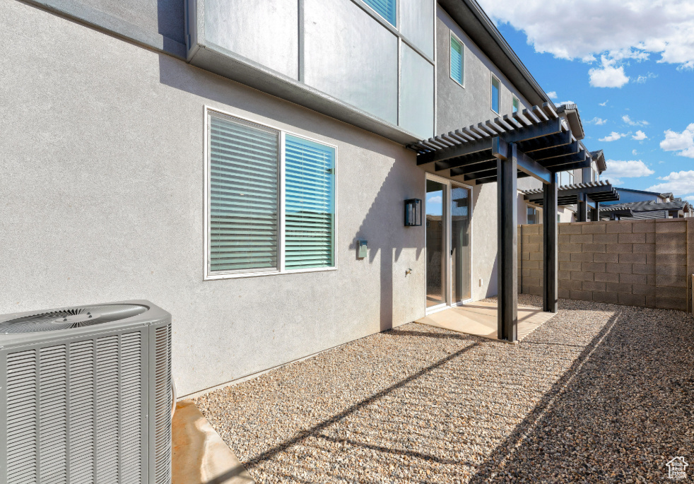 View of patio / terrace featuring central air condition unit, a pergola, and fence