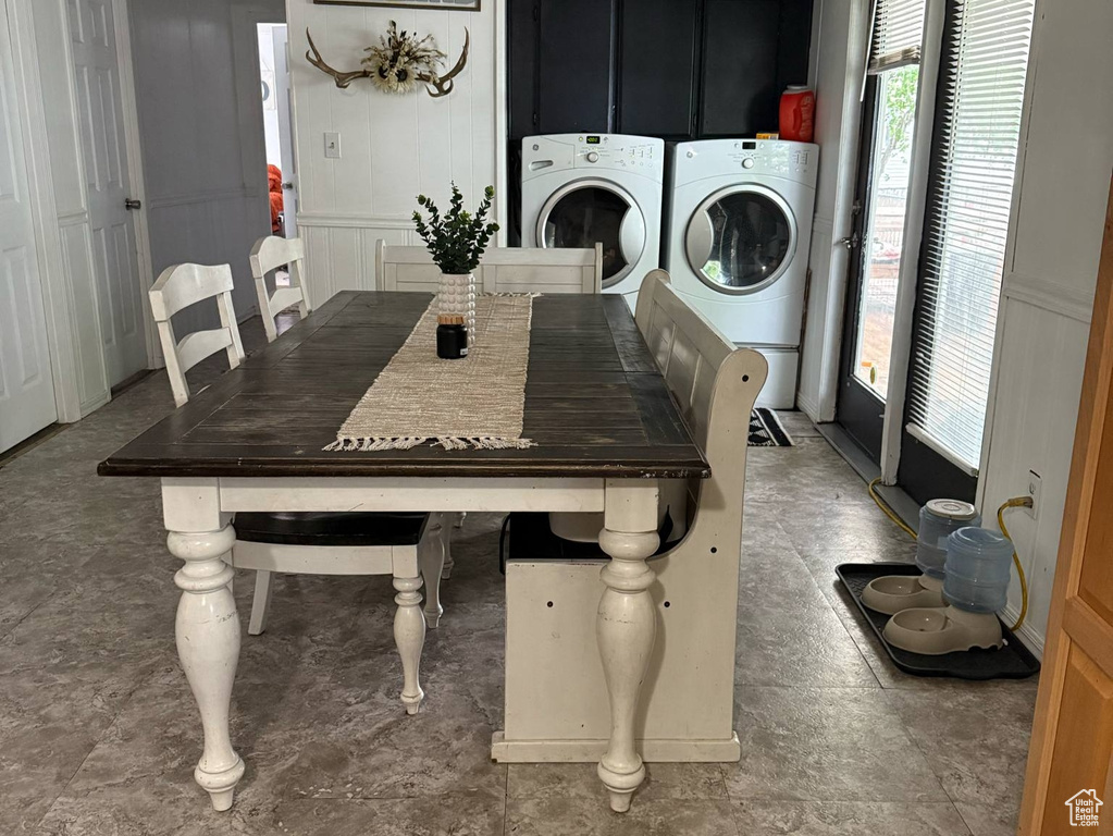 Dining area with washer and clothes dryer and a decorative wall