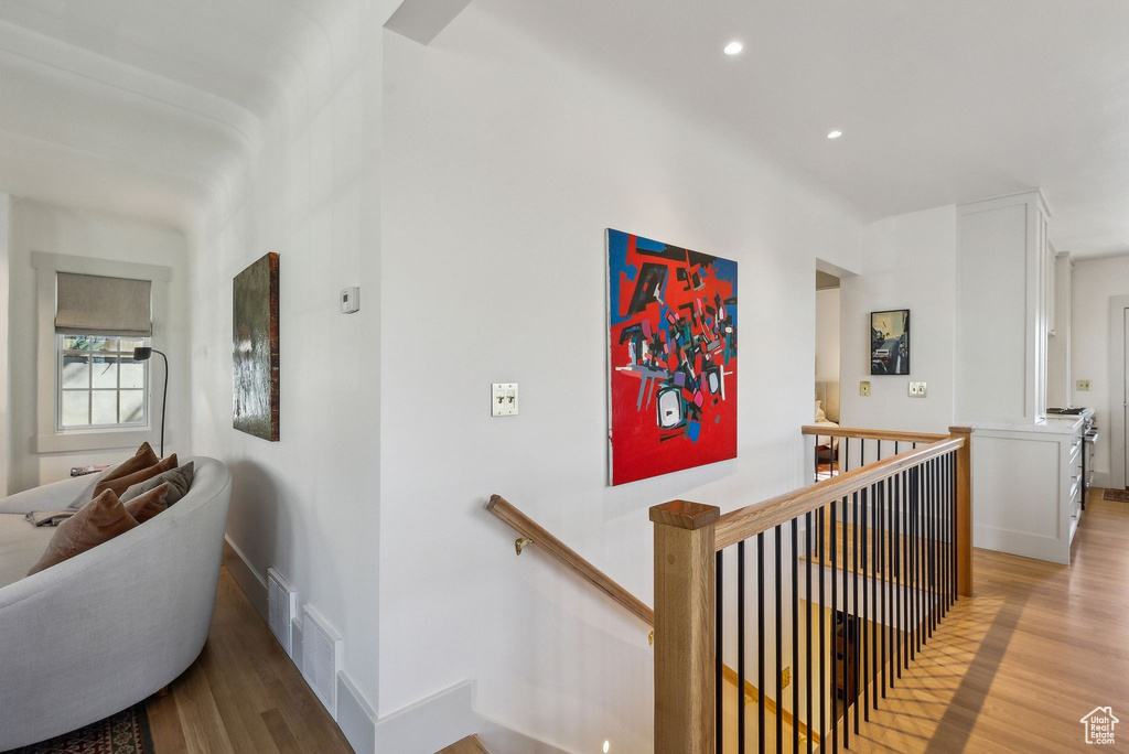 Staircase with visible vents, recessed lighting, wood finished floors, and baseboards