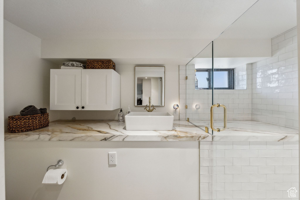 Full bathroom with a stall shower and a sink
