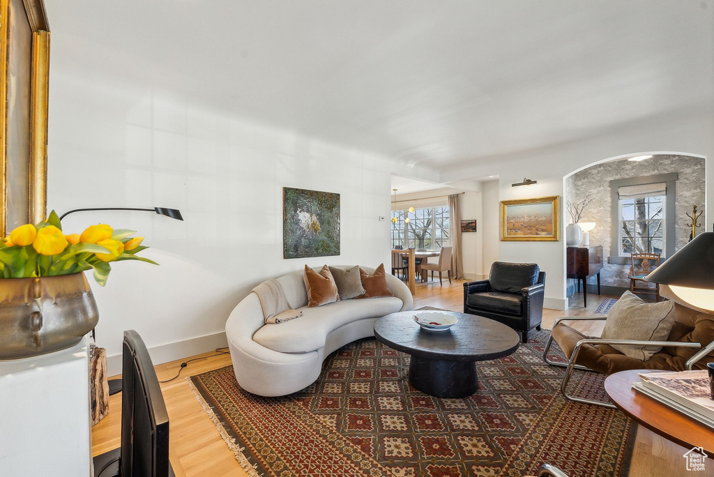 Living area featuring wood finished floors, baseboards, and a healthy amount of sunlight
