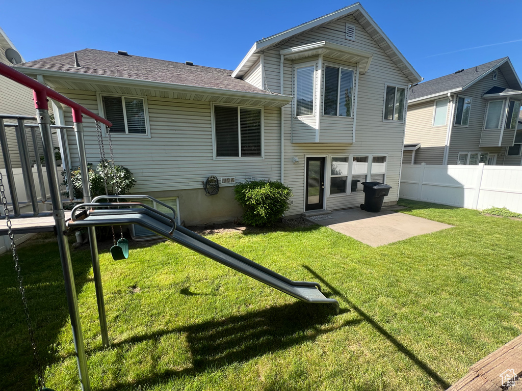 Back of property featuring a patio and roof with shingles