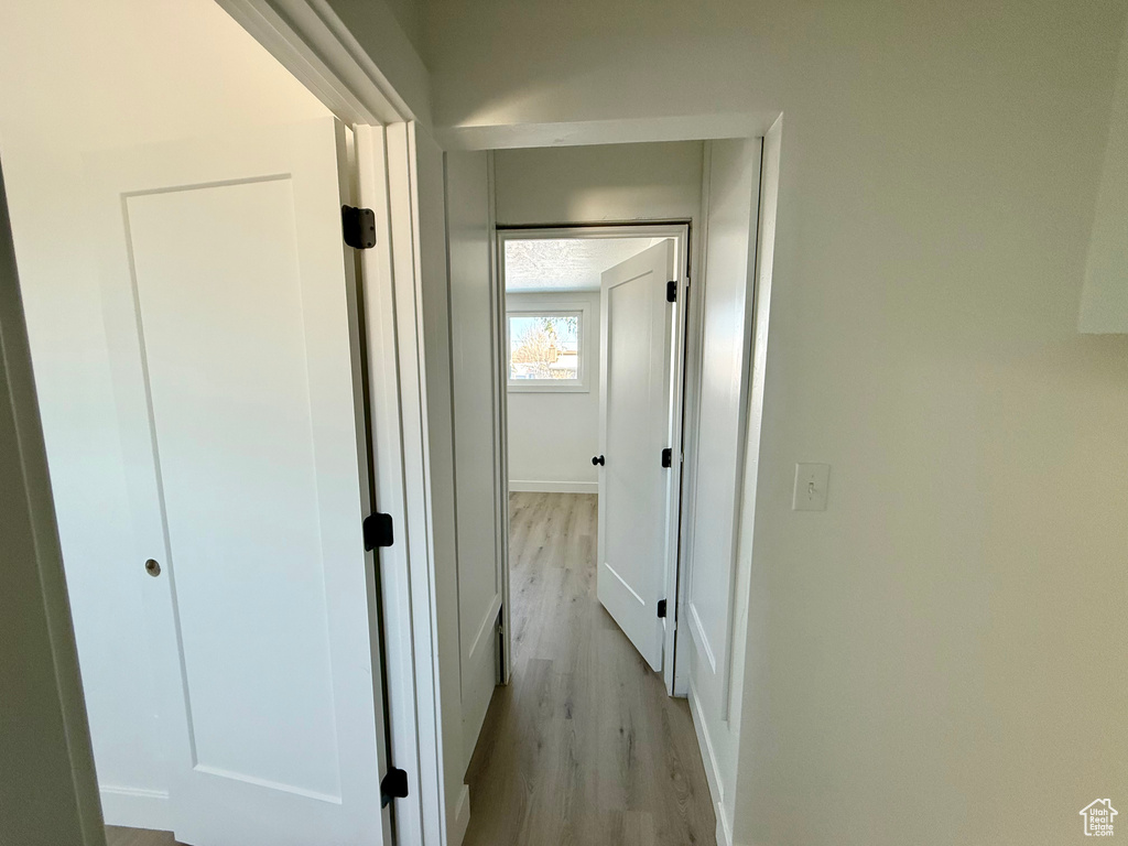 Hallway with light wood finished floors