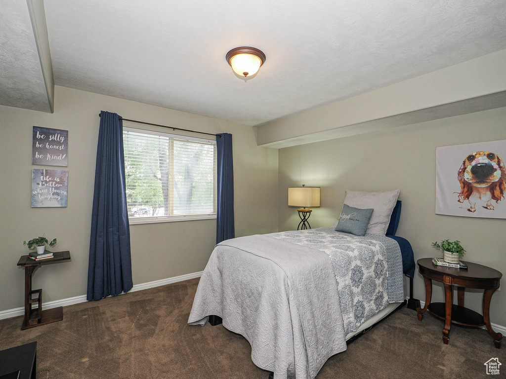 Bedroom featuring carpet floors and baseboards