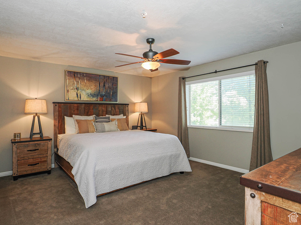Bedroom with baseboards, carpet, and a ceiling fan