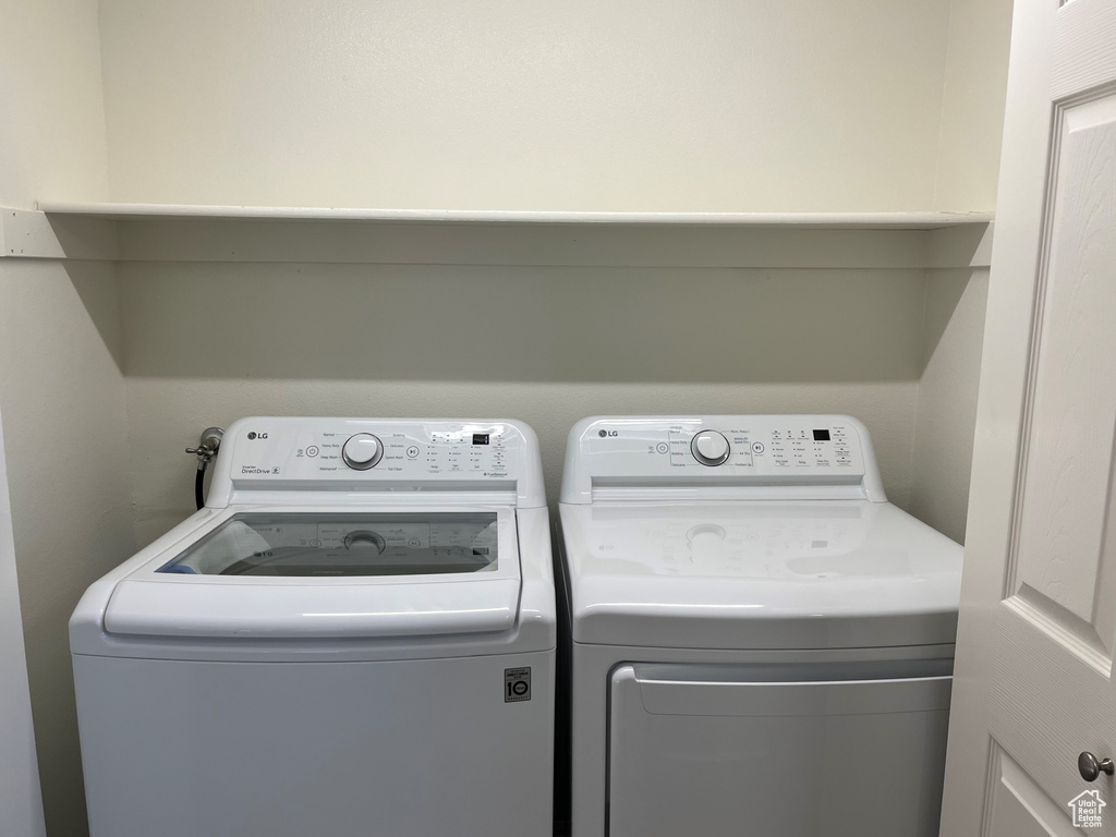Washroom featuring separate washer and dryer and laundry area