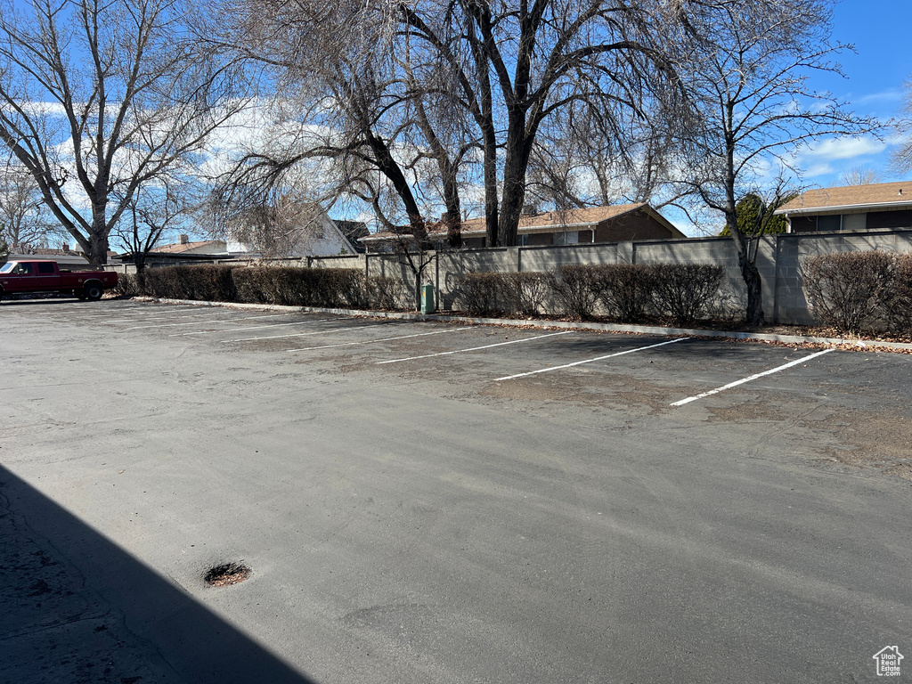 Uncovered parking lot featuring fence