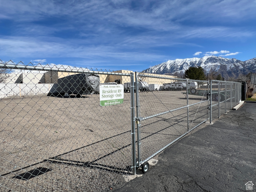 Exterior details featuring a gate, fence, and a mountain view