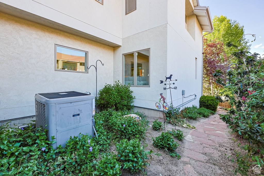 View of home\\\\\\\'s exterior with stucco siding and central AC