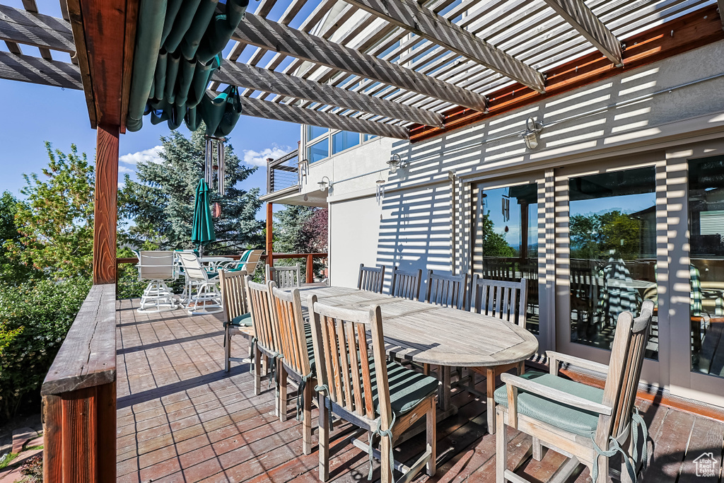 View of patio with a pergola and outdoor dining space