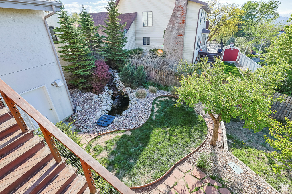 View of yard featuring a fenced backyard and a garden pond