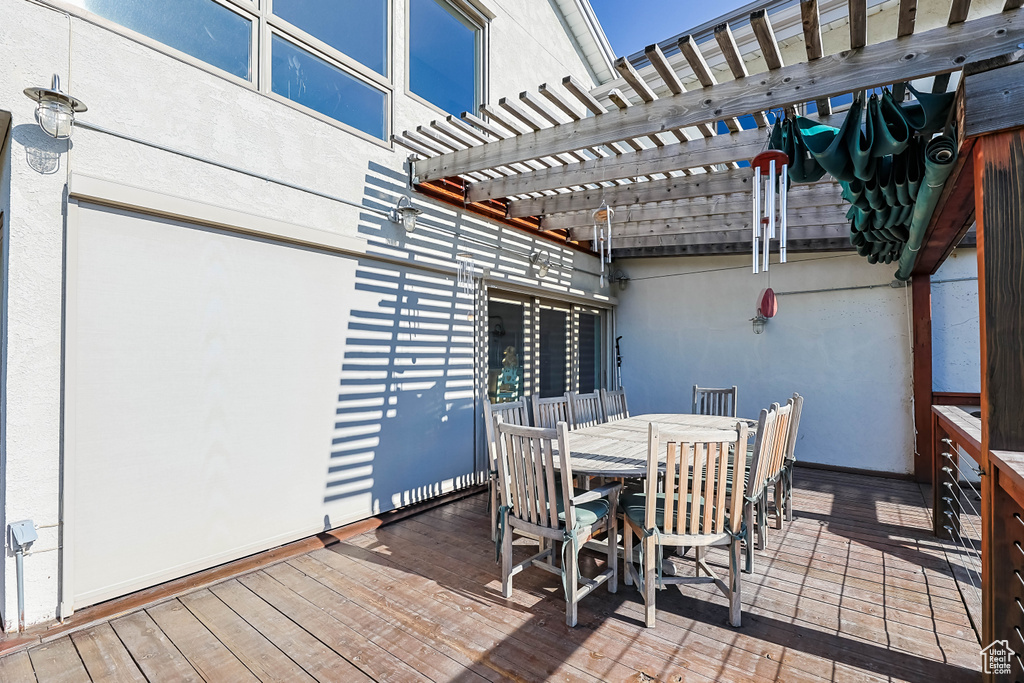 View of patio / terrace featuring a pergola, a wooden deck, and outdoor dining area