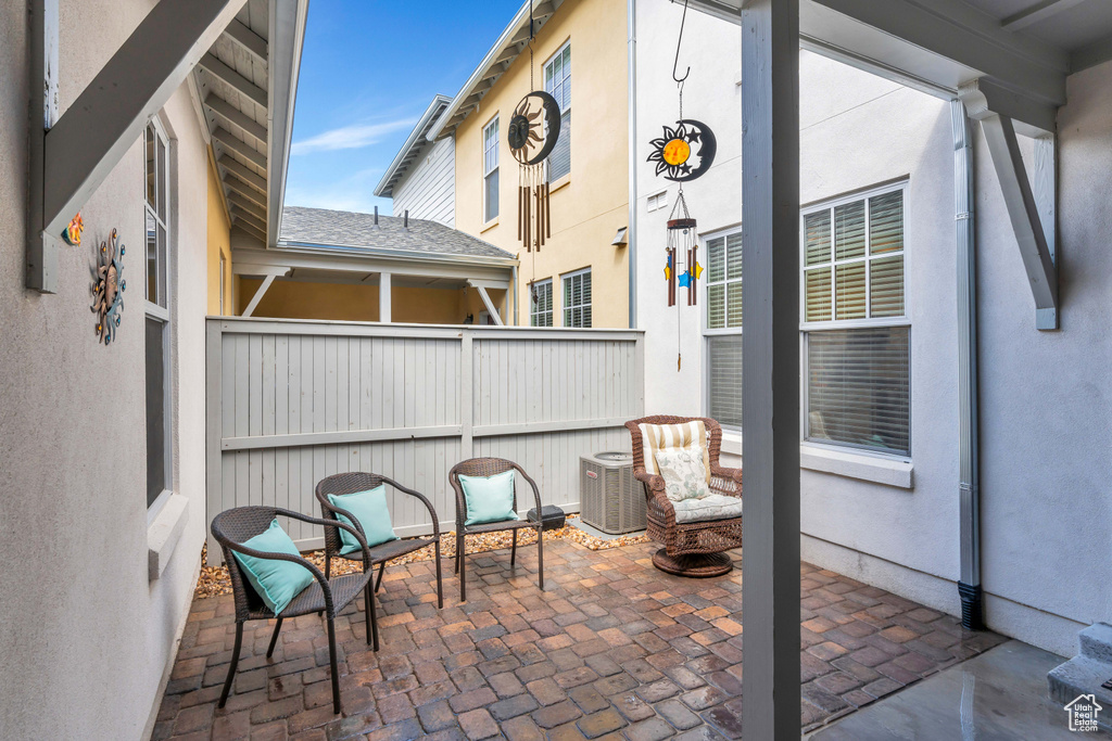 View of patio / terrace featuring central AC and fence