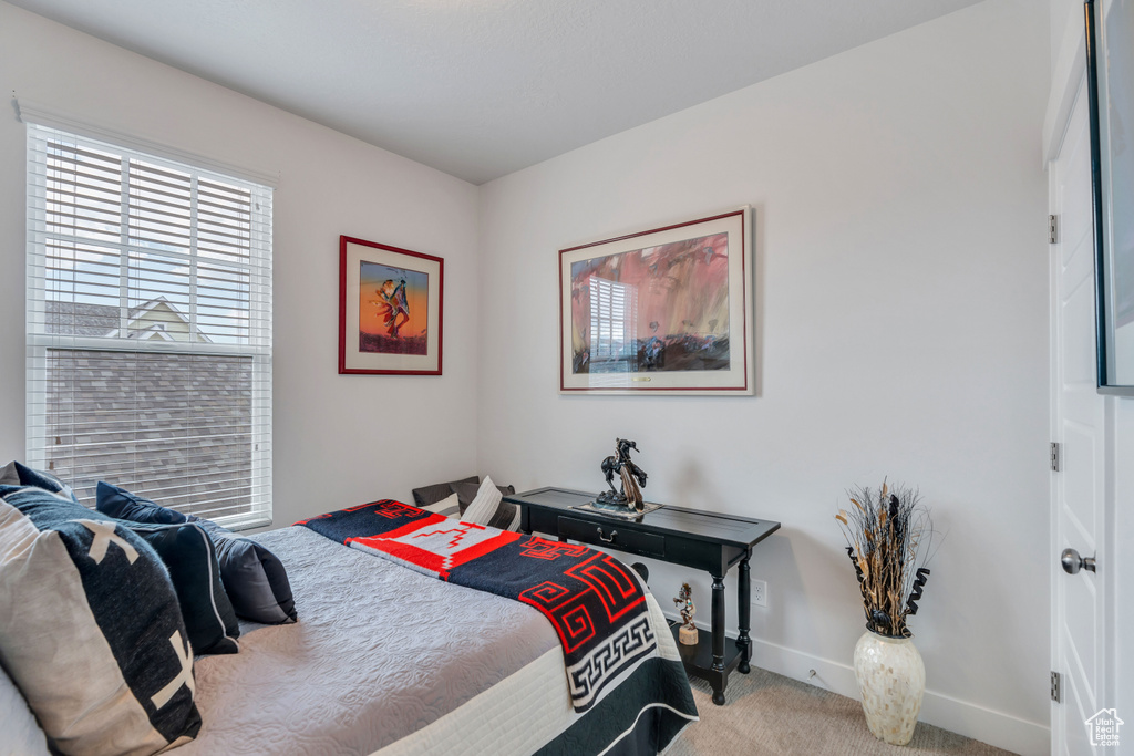Carpeted bedroom with baseboards