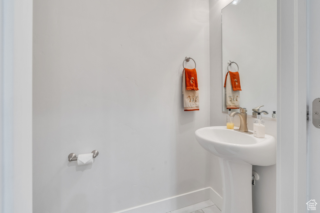 Bathroom with tile patterned flooring and baseboards