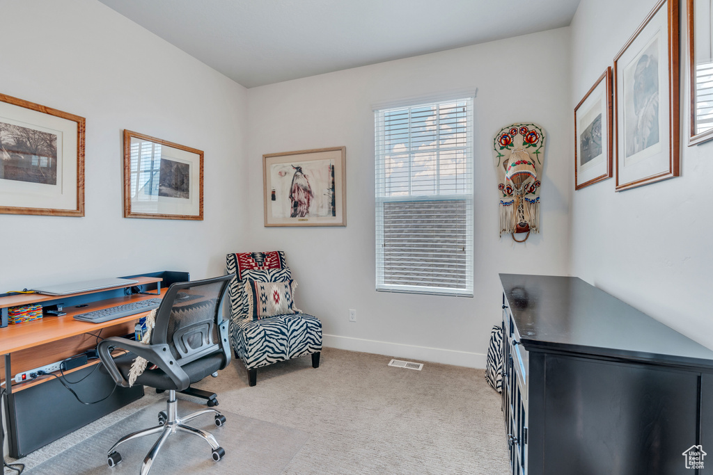 Office space featuring carpet flooring, visible vents, and baseboards