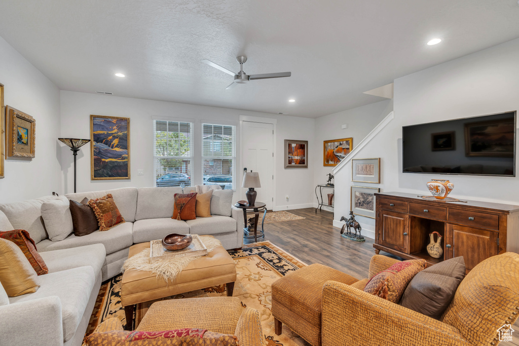 Living room featuring wood finished floors, recessed lighting, stairway, baseboards, and ceiling fan