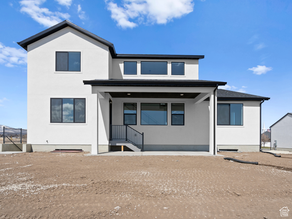 Back of property featuring stucco siding