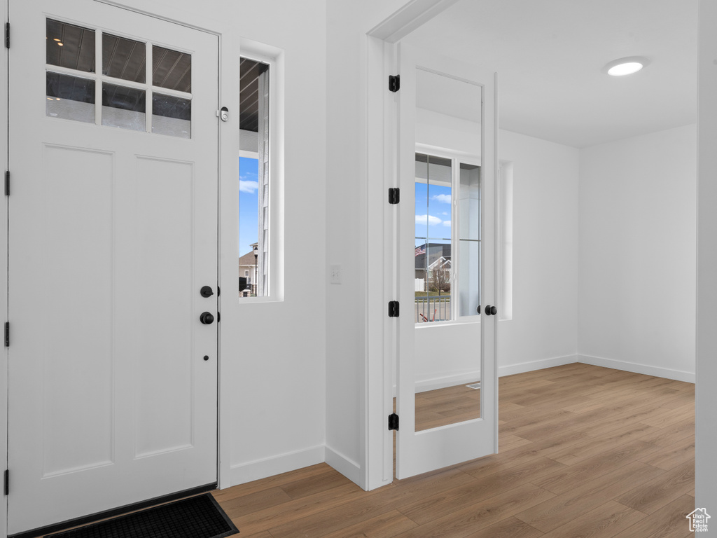 Entrance foyer featuring baseboards and light wood-style floors