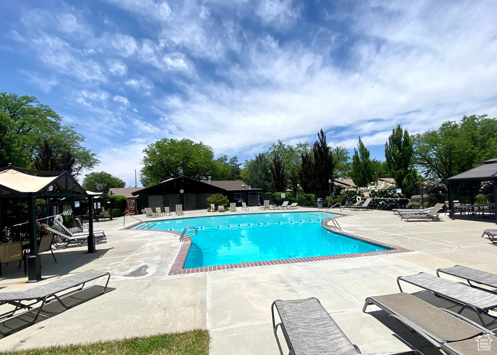 Pool featuring a patio and fence