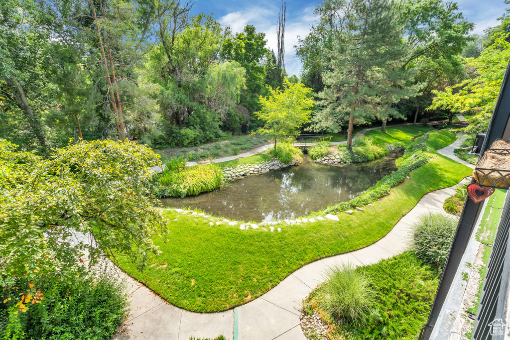 View of community with a small pond