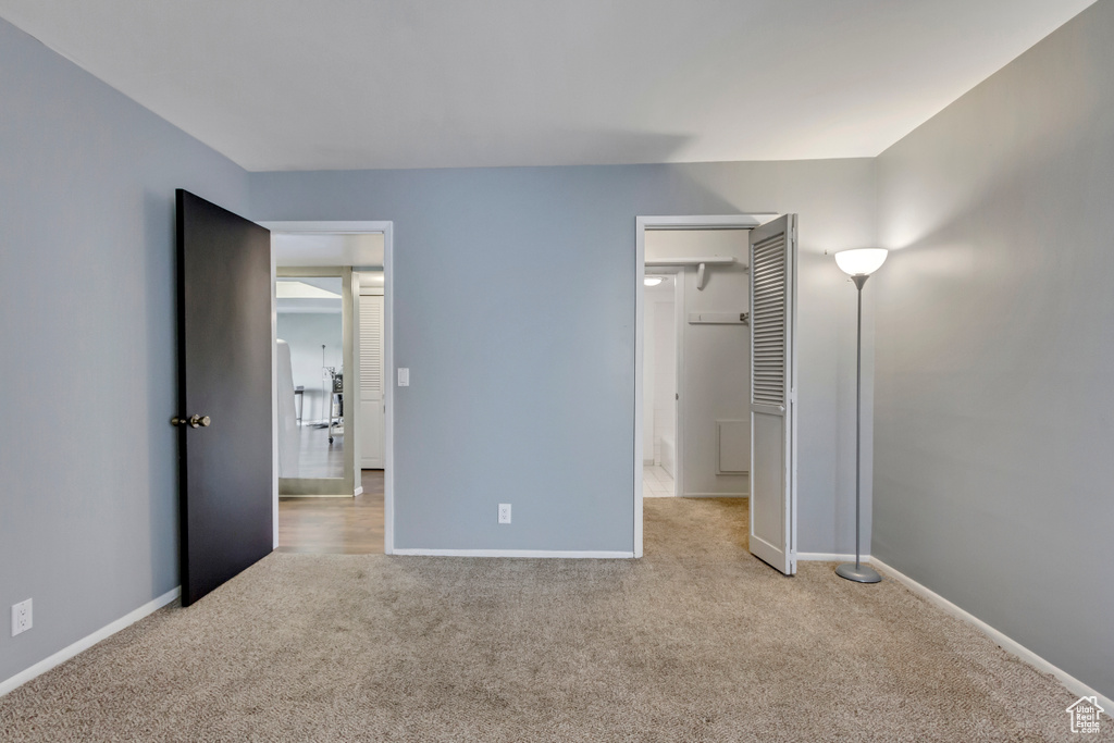 Unfurnished bedroom with baseboards and carpet