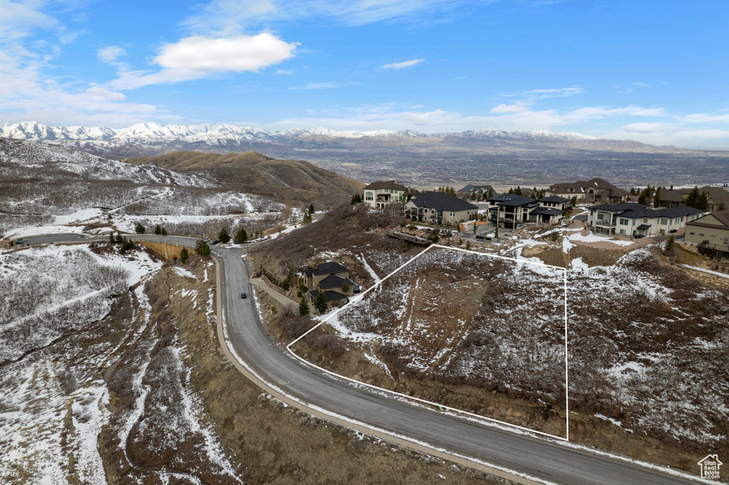 Snowy aerial view with a mountain view and a residential view