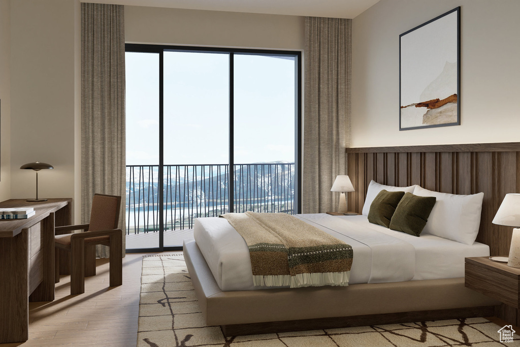 Bedroom featuring access to exterior and wood finished floors