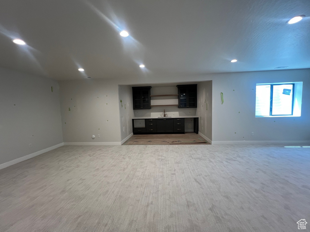 Unfurnished living room featuring a sink and recessed lighting