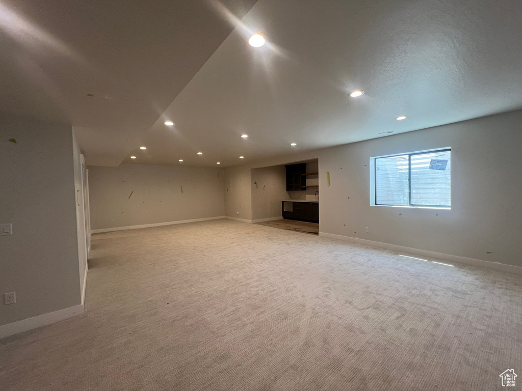Basement with recessed lighting and light colored carpet