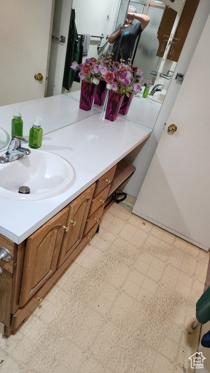 Bathroom with tile patterned floors and vanity