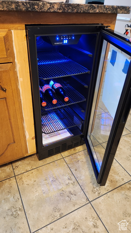Interior details with dark countertops and wine cooler