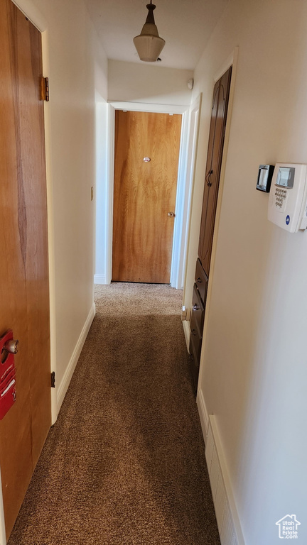 Hallway featuring carpet floors